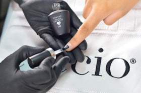 Cuccio Veneer Base bottle providing smooth foundation for even color.