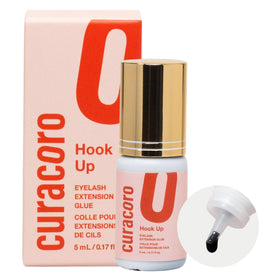 CURACORO eyelash glue bottle closeup showing extra-strong hold for salons.