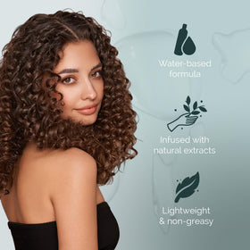 Hands spraying Curl Keeper Refresh for quick curl refresh between washes