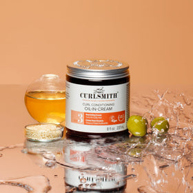 CURLSMITH Curl Conditioning Oil-in-Cream hair close-up after application.