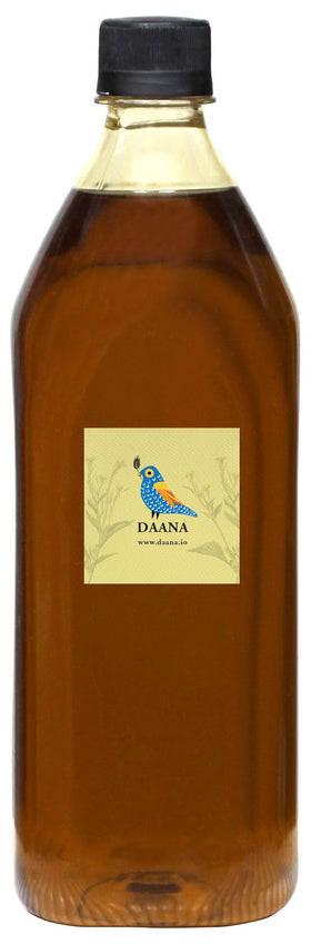 DAANA mustard oil pouring from glass bottle showcases rich texture for skin care.