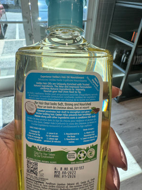 Close-up shows Dabur Vatika Naturals coconut oil texture