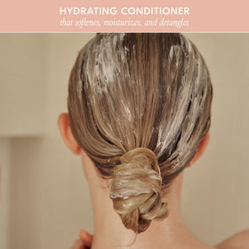 DAE Signature Conditioner application on hair promotes frizz control and natural shine