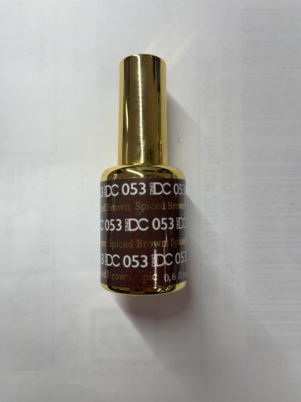 Daisy DND Walnut Brown nails showcase glossy, chip-free look.