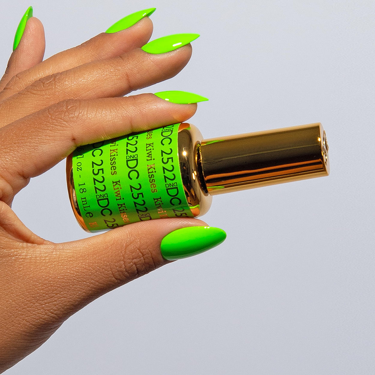 Daisy DND Kiwi Kisses gel bottle reveals vibrant bright green hue for playful nails.