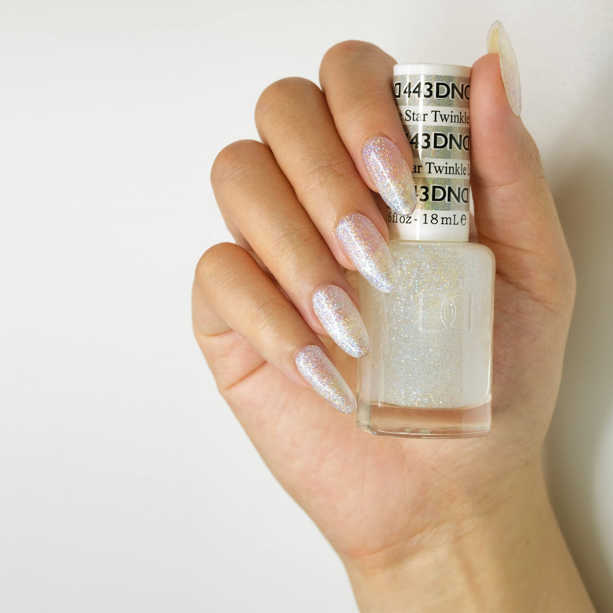 Daisy DND Twinkle Little Star lacquer bottle paired with gel polish.