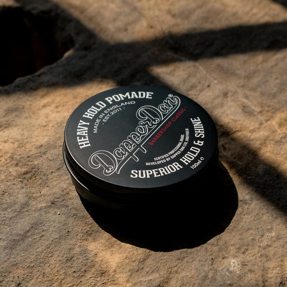 Dapper Dan Heavy Hold Pomade jar top view highlighting petrolatum-free formula for clean styling
