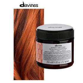 Davines Alchemic Copper conditioner bottle on damp hair showing even application