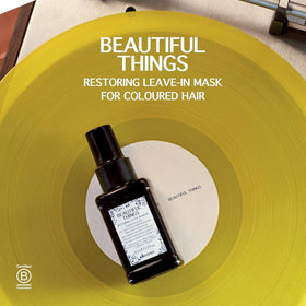 Hands applying Davines Beautiful Things Hair Mask for repair and shine