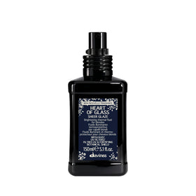 Davines Heart of Glass Sheer Glaze bottle close-up for brightening blondes.