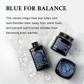 Davines Heart of Glass bottle under soft lighting, blue hue emphasized.