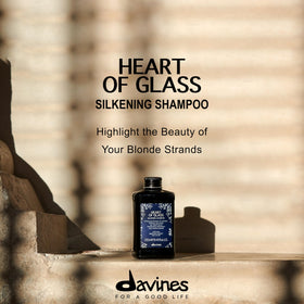 Davines Heart of Glass foam blooming on damp blonde hair.