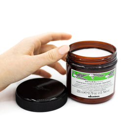 Close-up of ingredients label showing spinach and maqui berry for nourishing care.