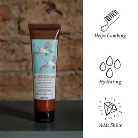 Conditioner being applied to damp hair to ease detangling.