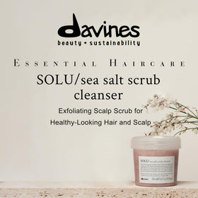 Davines SOLU paste on hand showing creamy texture for gentle scalp massage.