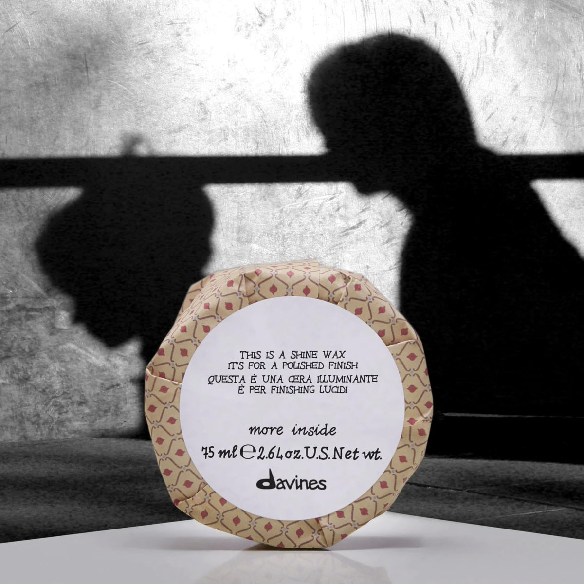 Davines This Is A Shine Wax smoothing flyaways and frizz with shine.