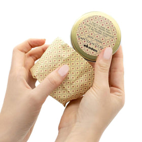 Davines This Is A Shine Wax applied to hair for a natural glossy finish.