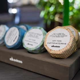 Davines This Is A Shine Wax packaging highlighting sustainable beauty values.