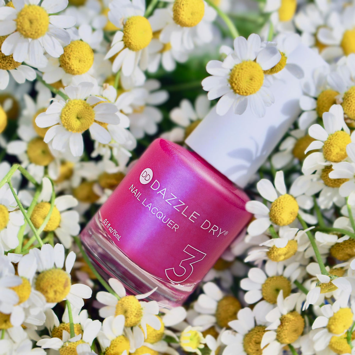 Dazzle Dry Beloved lacquer bottle shows vivid shimmer in natural light.
