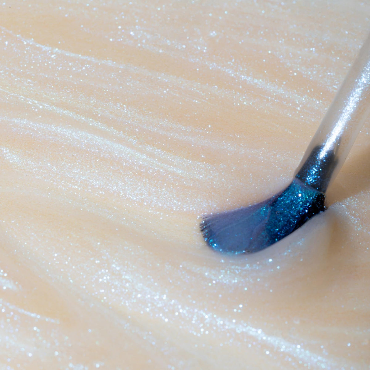 Dazzle Dry Inner Glow glitter-detail highlights blue specks under soft lighting.