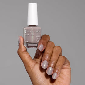 Dazzle Dry Lets Glow cap close-up on premium packaging details.