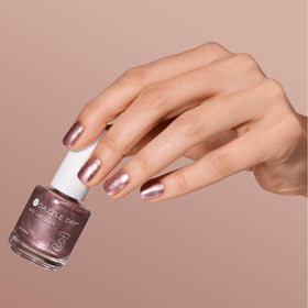 Rose gold reflection on the bottle suggests salon-quality home results.