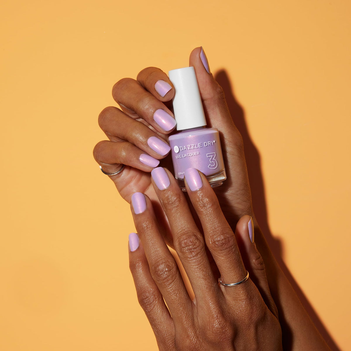 Dazzle Dry Lovely Lilac nails on hand displaying full-coverage shimmer.
