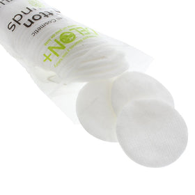 Close-up texture shows lint-free softness of DELON cotton rounds.