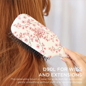 Denman air-cushioned pad cushions scalp for gentle grooming.