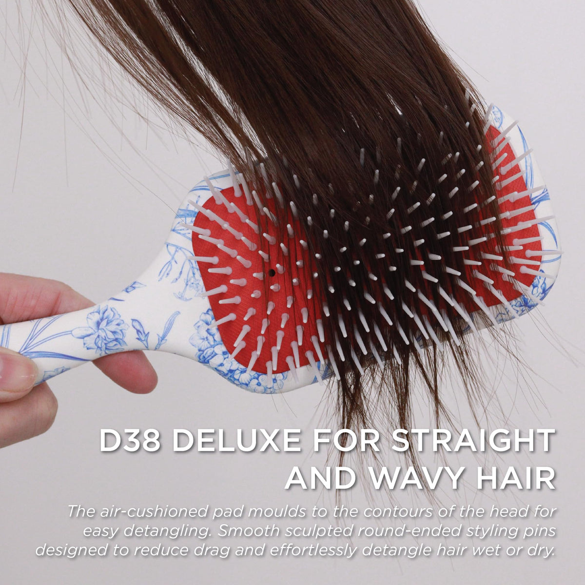 Denman D38 paddle helping gentle detangling across tangled strands without pulling.