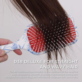 Denman D38 paddle helping gentle detangling across tangled strands without pulling.