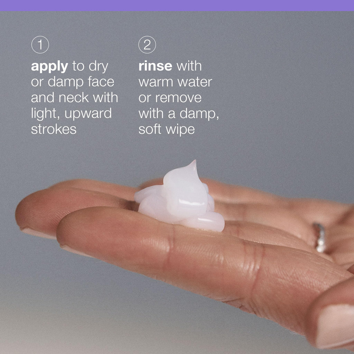 Hands massaging face with cleanser using gentle upward strokes