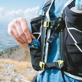 Compact sunscreen tin for outdoor protection during activities and travel.
