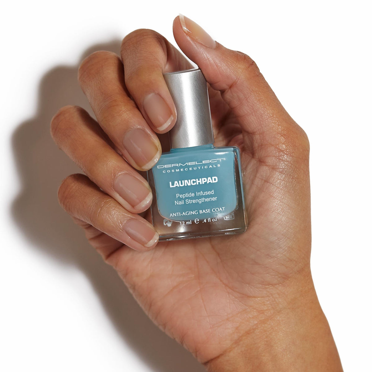 Launchpad brush applies quick-drying base coat on nails.