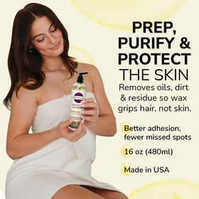 Dermwax label close-up shows witch hazel and botanical focus.