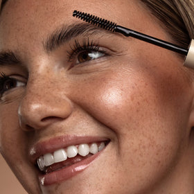 DIME Beauty ingredient blend label highlights nourishing peptides and caffeine for brow health.
