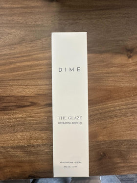 DIME Glaze Body Oil blend close-up highlights argan and rosehip among nourishing oils.