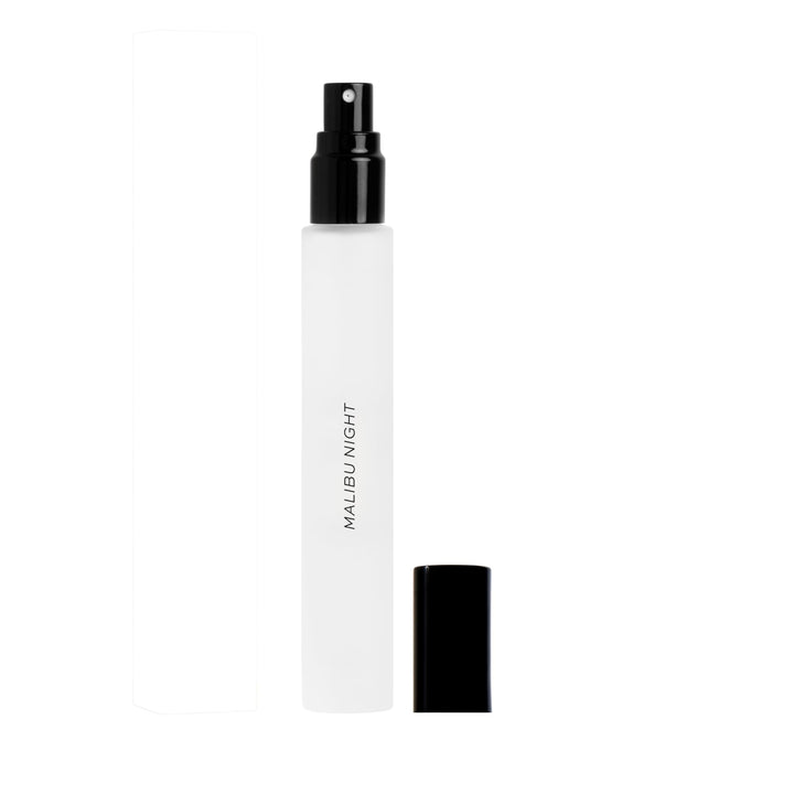 DIME Malibu Night bottle bathed in sunset glow, ideal for evening wear.