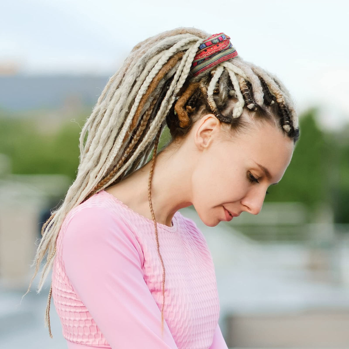 Dingion dreadlock tie on long hair demonstrates easy ponytail creation.