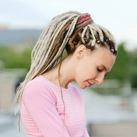 Dingion dreadlock tie on long hair demonstrates easy ponytail creation.