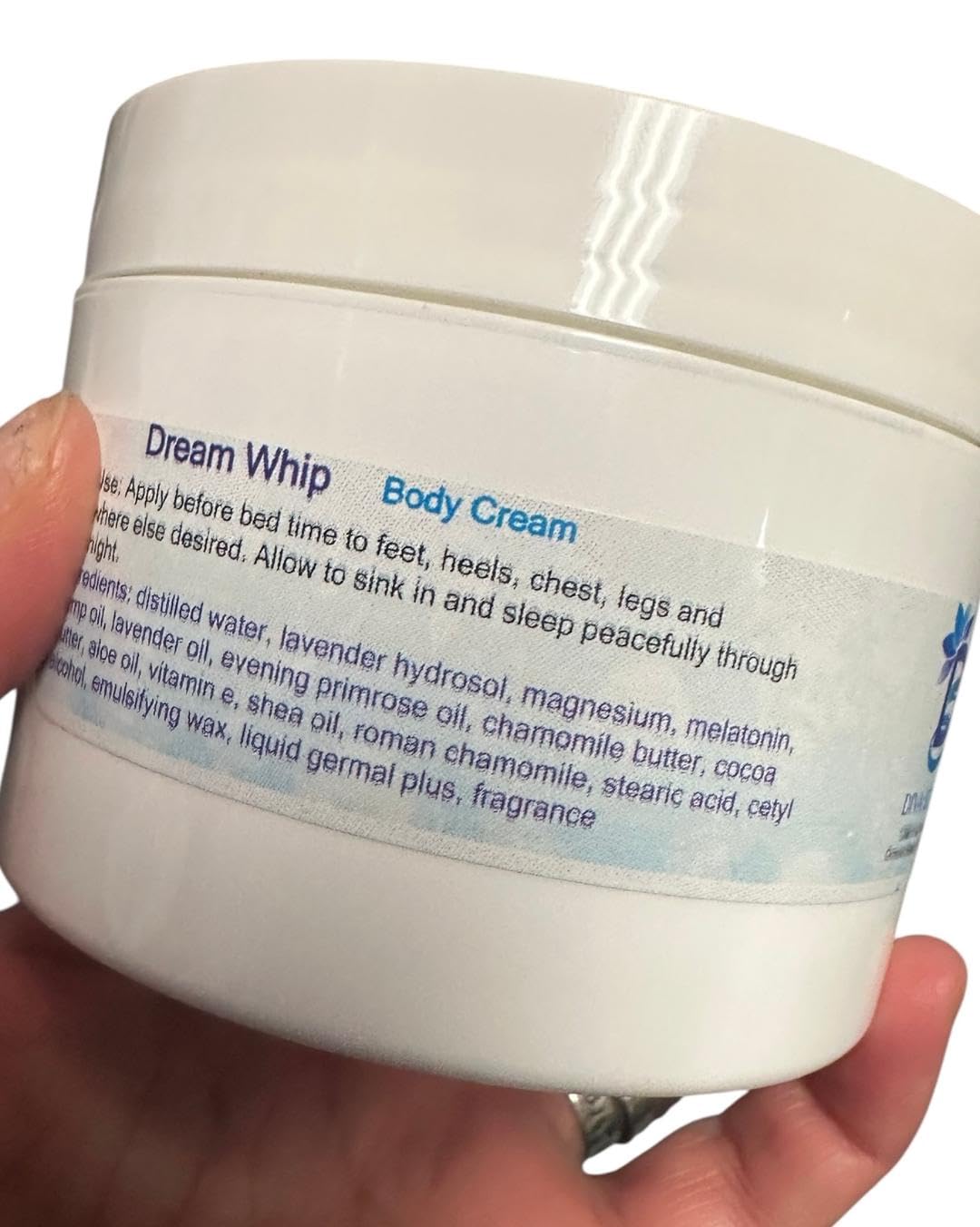 Diva Stuff Dream Whip cream massaged into hands for soft, hydrated skin.