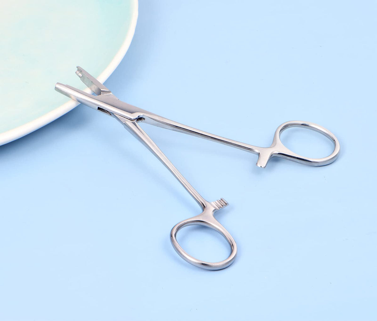 DJCIW piercing ball removal pliers in action, showcasing the screw mechanism