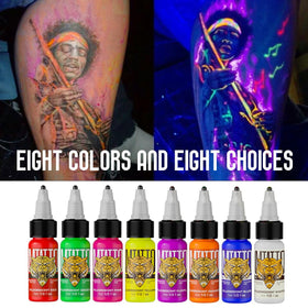 DMTATTOO fluorescent ink set packshot with eight color bottles ready for vibrant designs