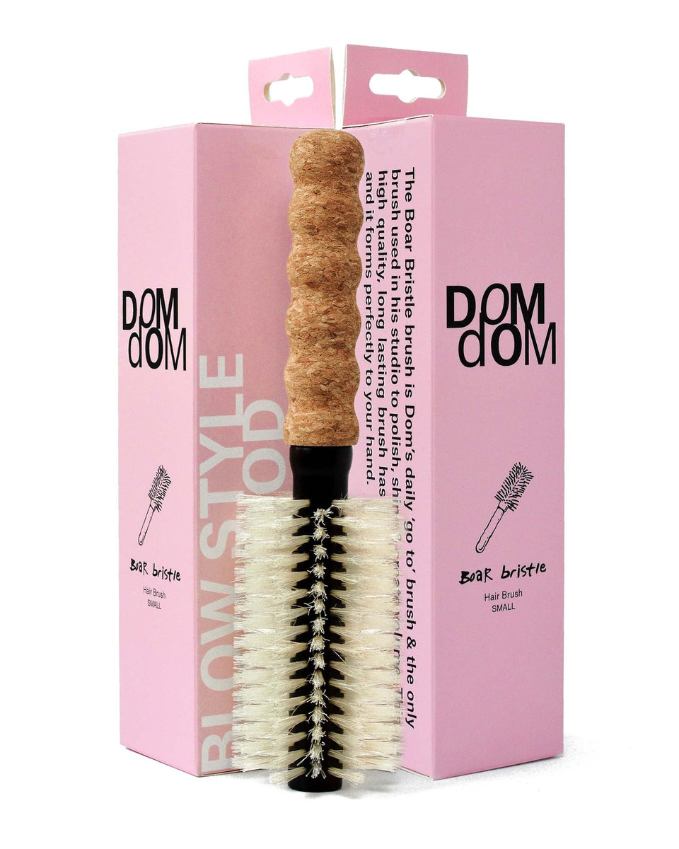 Dom Dom round brush with cork handle close-up highlighting ergonomic grip and bristles.