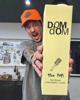 Dom Dom smoothing brush in use on damp hair speeds drying.