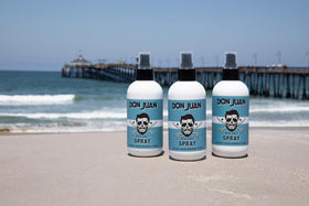 Applying Don Juan Sea Salt Hair Spray for quick texture and volume.