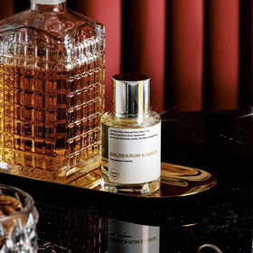 Dossier Golden Rum & Amber being applied on pulse points for lasting scent.