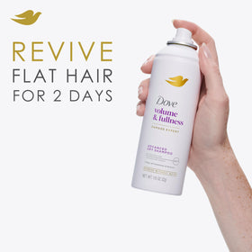 Hands massage Dove Advanced Dry Shampoo into roots to absorb oil.