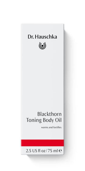 Texture close-up of Dr. Hauschka Blackthorn Toning Body Oil highlights silky oil for skin nourishment.