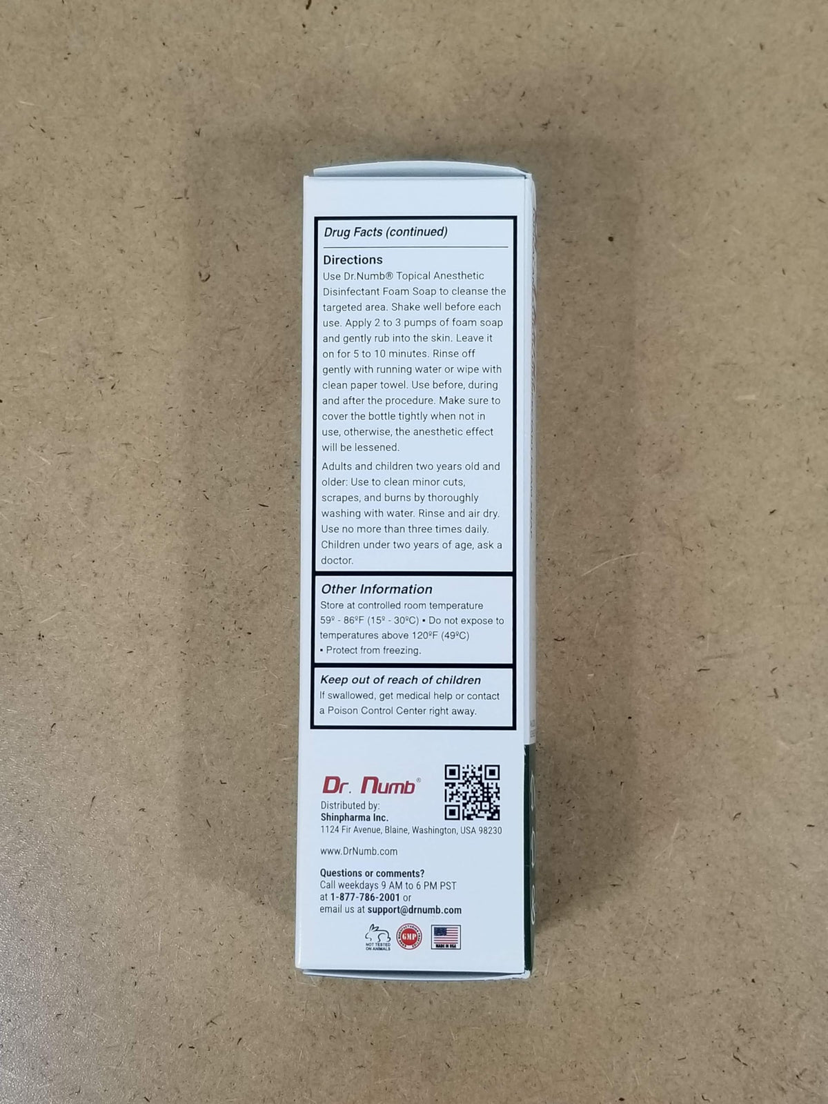 Hand holding Dr. Numb bottle for portability.